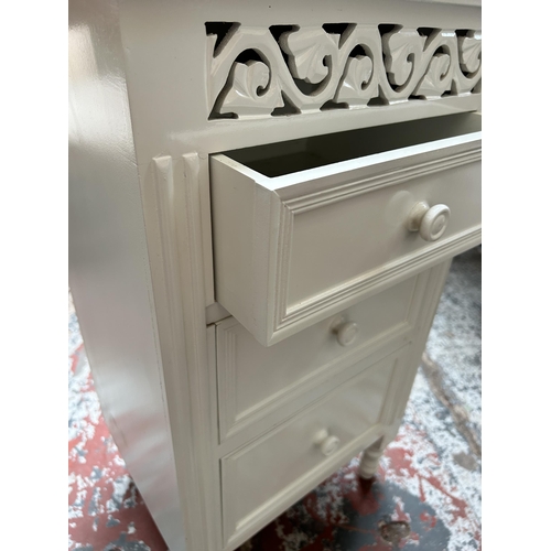 76 - A French style white painted bedside chest of three drawers