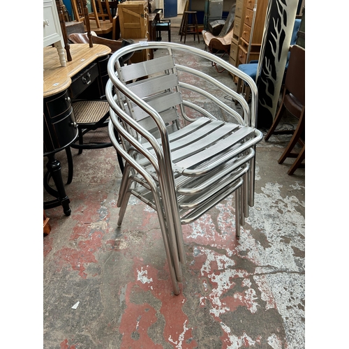 79 - Four tubular metal bistro dining chairs