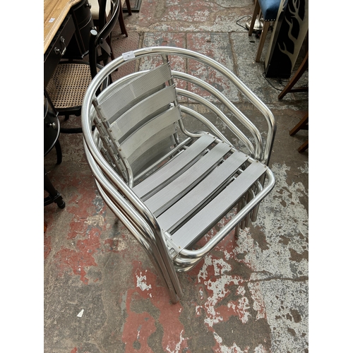 79 - Four tubular metal bistro dining chairs