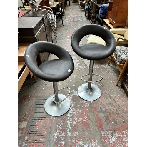84 - A pair of brown leatherette and chrome plated kitchen bar stools