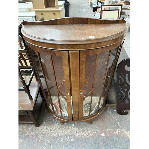 178 - A walnut bow fronted display cabinet with three glass shelves and two glazed doors