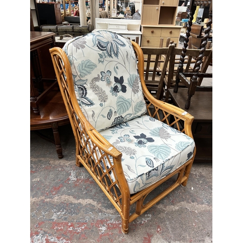 180 - A bamboo and wicker conservatory armchair with floral upholstery