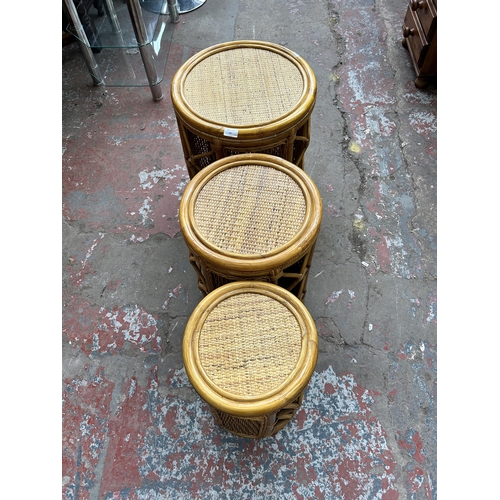 181 - A bamboo and wicker circular nest of three tables