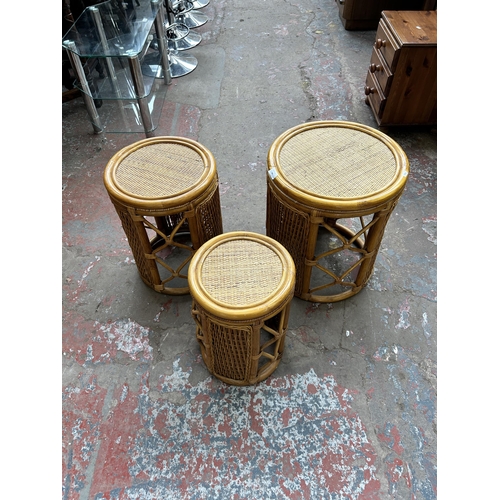 181 - A bamboo and wicker circular nest of three tables