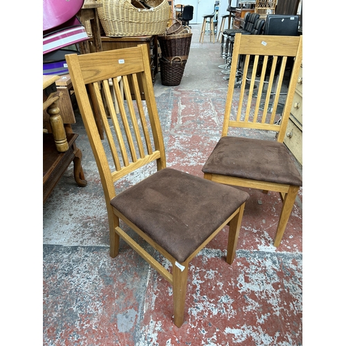 196 - A pair of oak and brown suede dining chairs