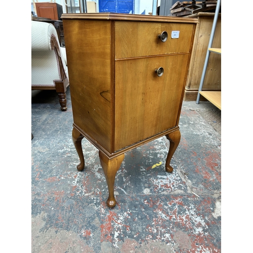 203 - A Heirloom walnut bedside cabinet with cabriole supports