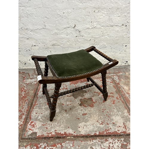 206 - An early 20th bobbin turned beech and green fabric upholstered twin handled stool