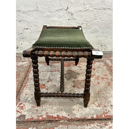 206 - An early 20th bobbin turned beech and green fabric upholstered twin handled stool