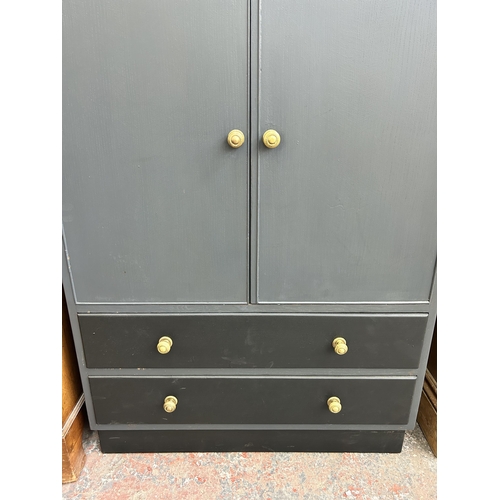 208 - A mid 20th century grey painted cabinet with two cupboard doors and two lower drawers