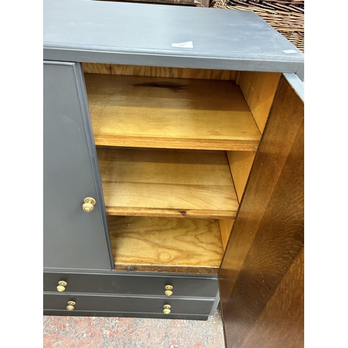 208 - A mid 20th century grey painted cabinet with two cupboard doors and two lower drawers