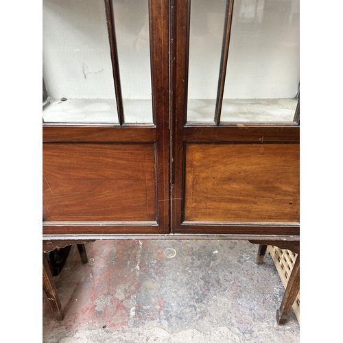 219 - An Edwardian inlaid mahogany display cabinet with two glazed doors