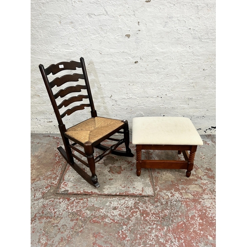 220 - Two pieces of furniture, one elm and rush seated rocking chair and one cherry wood and fabric uphols... 