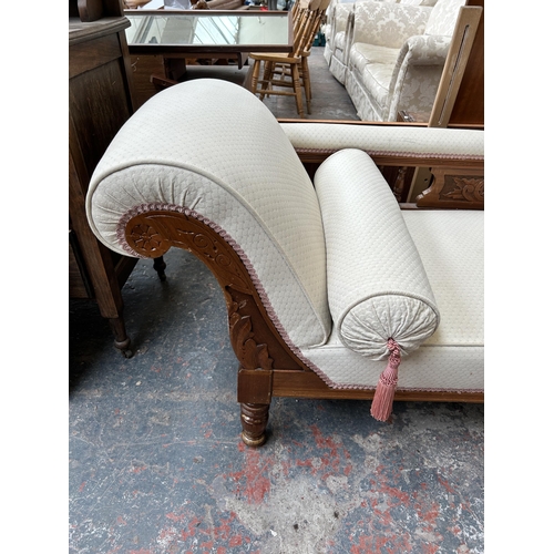 223 - An Edwardian carved walnut and fabric upholstered chaise lounge