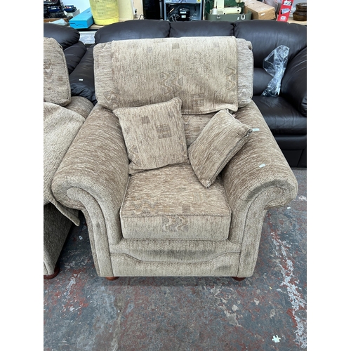 240 - A brown fabric upholstered two piece lounge suite comprising three seater sofa and armchair