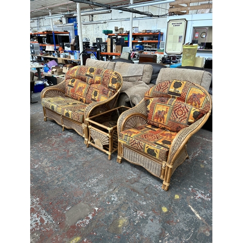 241 - A bamboo and wicker three piece conservatory suite comprising two seater sofa, armchair and rectangu... 