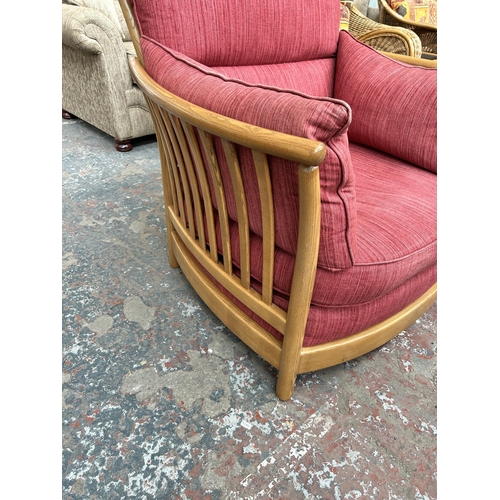 243 - An Ercol Renaissance elm and red fabric armchair