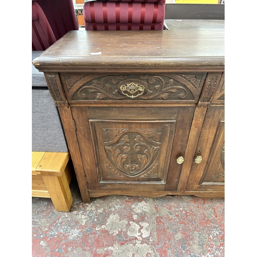 89 - An Edwardian carved mahogany sideboard with two drawers and two cupboard doors