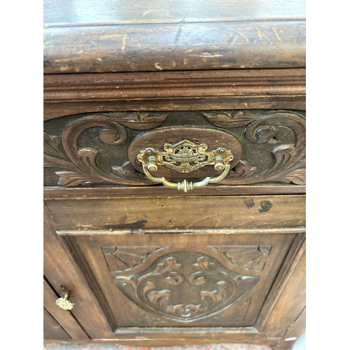 89 - An Edwardian carved mahogany sideboard with two drawers and two cupboard doors