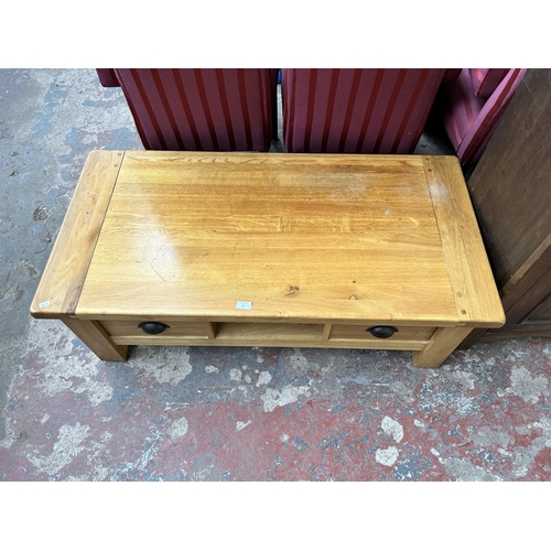 91 - A solid oak rectangular coffee table with two drawers