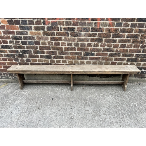 95 - An early 20th century oak bench - approx. 47cm high x 24cm wide x 244cm long