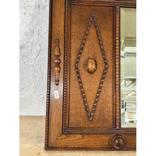 290 - An early 20th century carved and beaded oak framed bevelled edge wall mirror - approx. 54cm high x 9... 