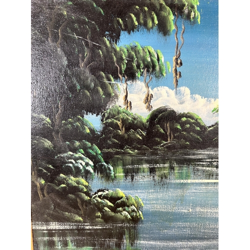 295 - A mid 20th century gilt framed oil on board of a jungle scene - approx. 43cm high x 56cm wide