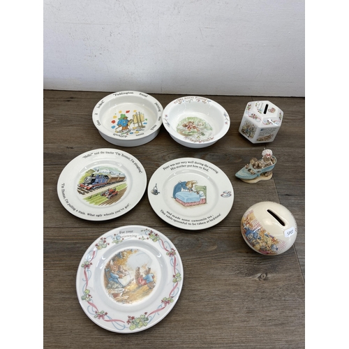 394 - A collection of ceramics to include two Coalport Paddington Bear bowls, Royal Doulton Bunnykins mone... 