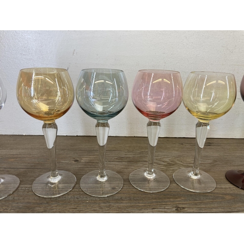 443 - Seventeen mid 20th century coloured and twisted glass wine glasses