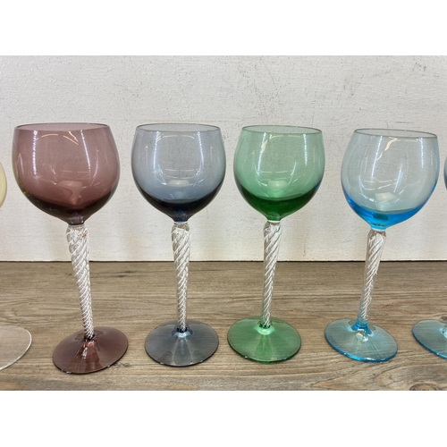 443 - Seventeen mid 20th century coloured and twisted glass wine glasses