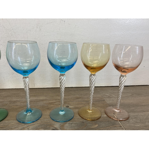 443 - Seventeen mid 20th century coloured and twisted glass wine glasses