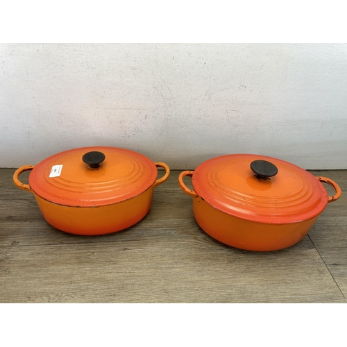 449 - Five pieces of Le Creuset orange enamel and cast iron kitchenware, two casserole dishes and three sa... 