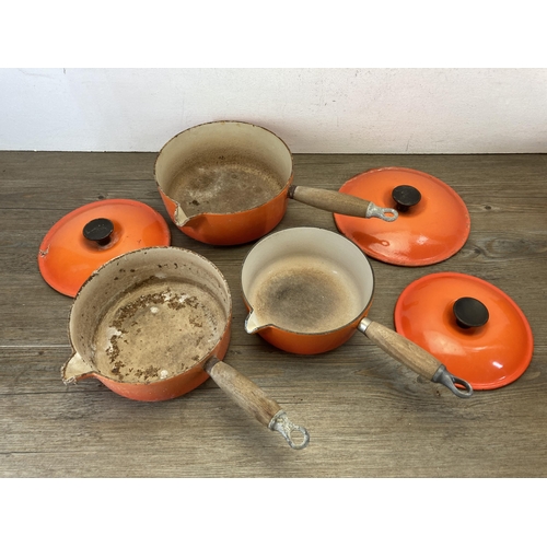 449 - Five pieces of Le Creuset orange enamel and cast iron kitchenware, two casserole dishes and three sa... 