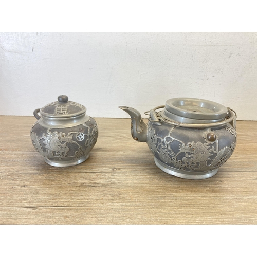 453 - A Chinese Wen Hua Shun pewter and ceramic four piece tea set