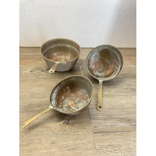 462 - Ten pieces of 19th century graduating copperware, seven jugs stamped HR and three colanders