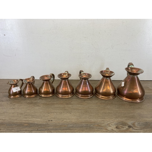 462 - Ten pieces of 19th century graduating copperware, seven jugs stamped HR and three colanders