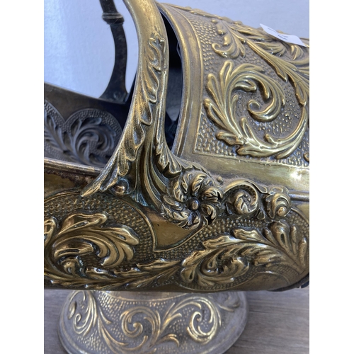 464 - A Victorian embossed brass coal scuttle with ebonised handle - approx. 43cm high x 45cm long