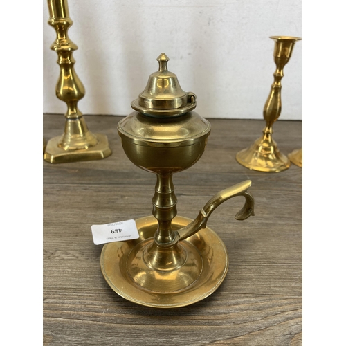 489 - Seven pieces of brassware, six candlesticks and one chamberstick