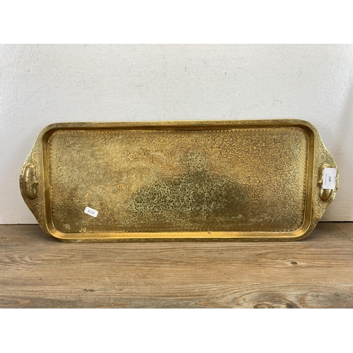 497 - A collection of metalware to include 1930s/40s brass pillow purse, Indian enamelled brass lidded bow... 