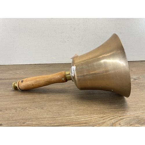 498 - An antique brass hand bell with turned wooden handle - approx. 31cm high