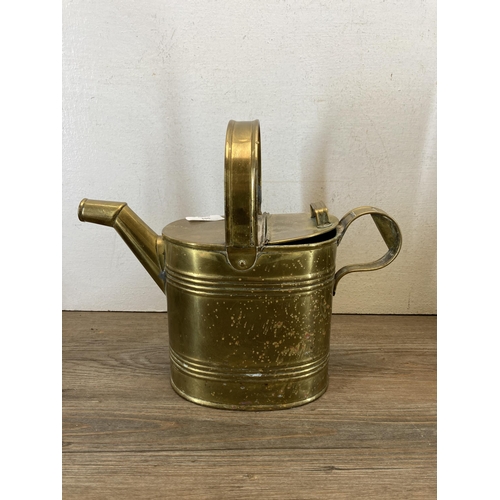 501 - Four pieces of brassware to include Victorian preserve pan, Victorian watering can etc.