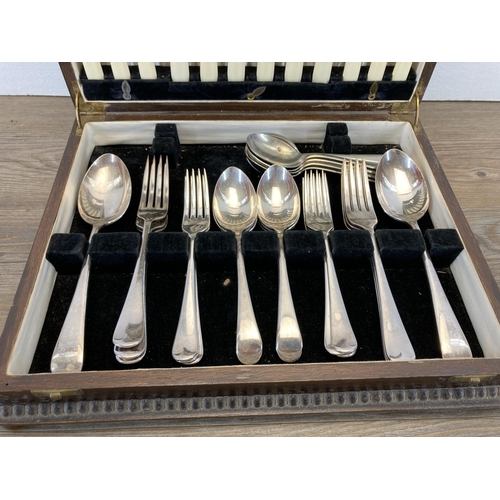 502 - An oak canteen of silver plated and stainless steel cutlery to include Viners Ltd etc.