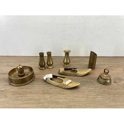 504 - A collection of copper and brassware to include miniature candlesticks, WWII trench art ashtray date... 