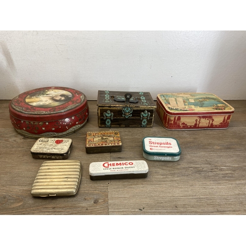 505 - A collection of metalware to include oak and chrome plated candlesticks, vintage advertising tins et... 