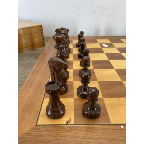 521 - A carved wooden chess set and board