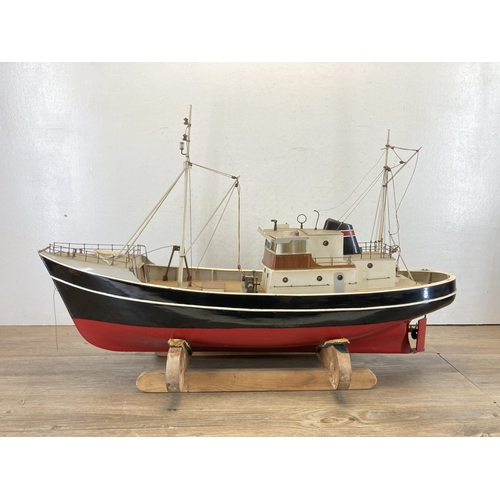 533 - A scratch built hand painted model boat on wooden stand - approx. 49cm high x 20cm wide x 80cm long