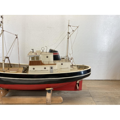 533 - A scratch built hand painted model boat on wooden stand - approx. 49cm high x 20cm wide x 80cm long