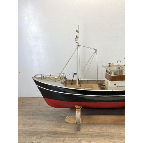 533 - A scratch built hand painted model boat on wooden stand - approx. 49cm high x 20cm wide x 80cm long