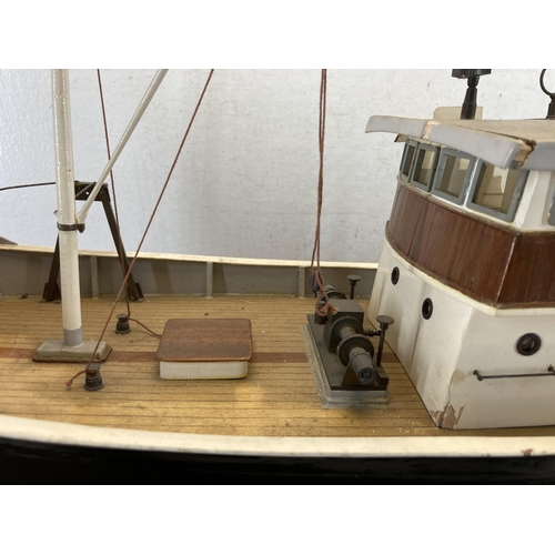 533 - A scratch built hand painted model boat on wooden stand - approx. 49cm high x 20cm wide x 80cm long