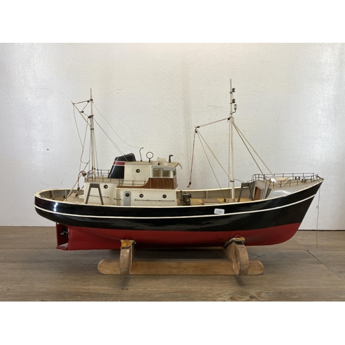 533 - A scratch built hand painted model boat on wooden stand - approx. 49cm high x 20cm wide x 80cm long