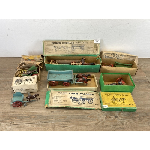 534 - A collection of boxed Britains hand painted lead horse and carriage figures together with a Charbens... 